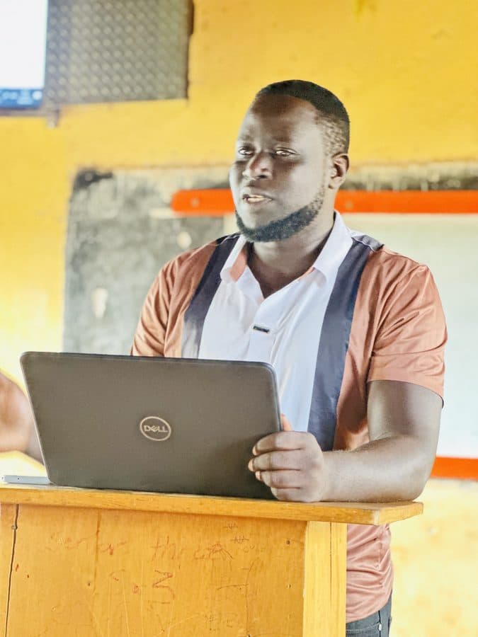 An ICT trainer presenting from a laptop during a training session